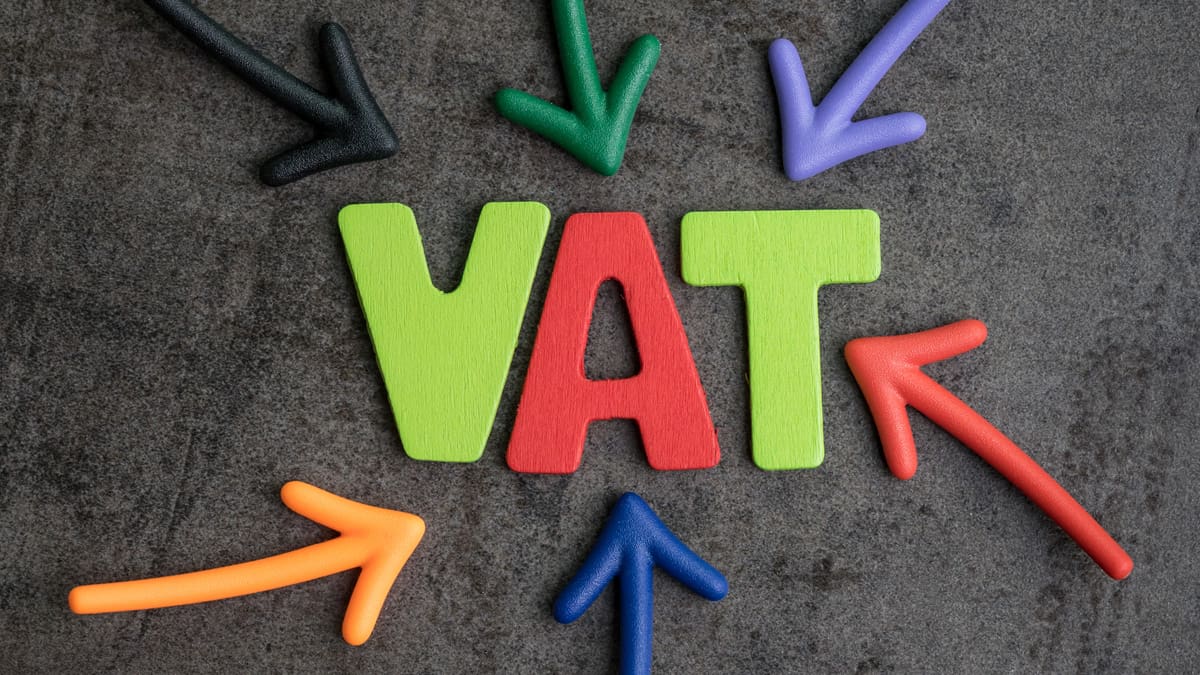 Important of VAT colorful text and arrows pointing to the word VAT at the center on black cement wall